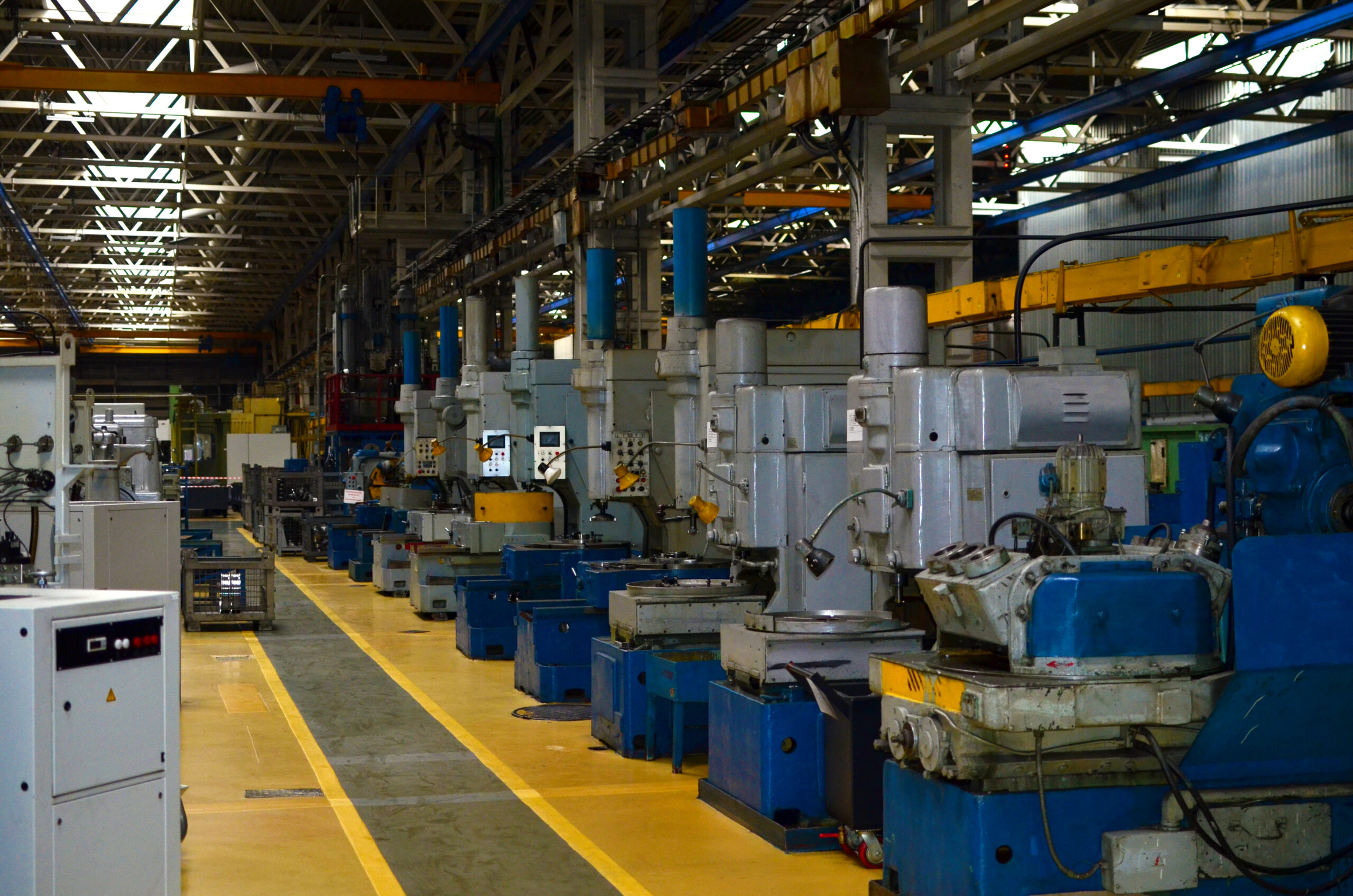 Inside of the industrial Plant. Workshop of a automotive factory with CNC machine for Production of Truck Sized Bevel Gears. Soft focus, possible granularity